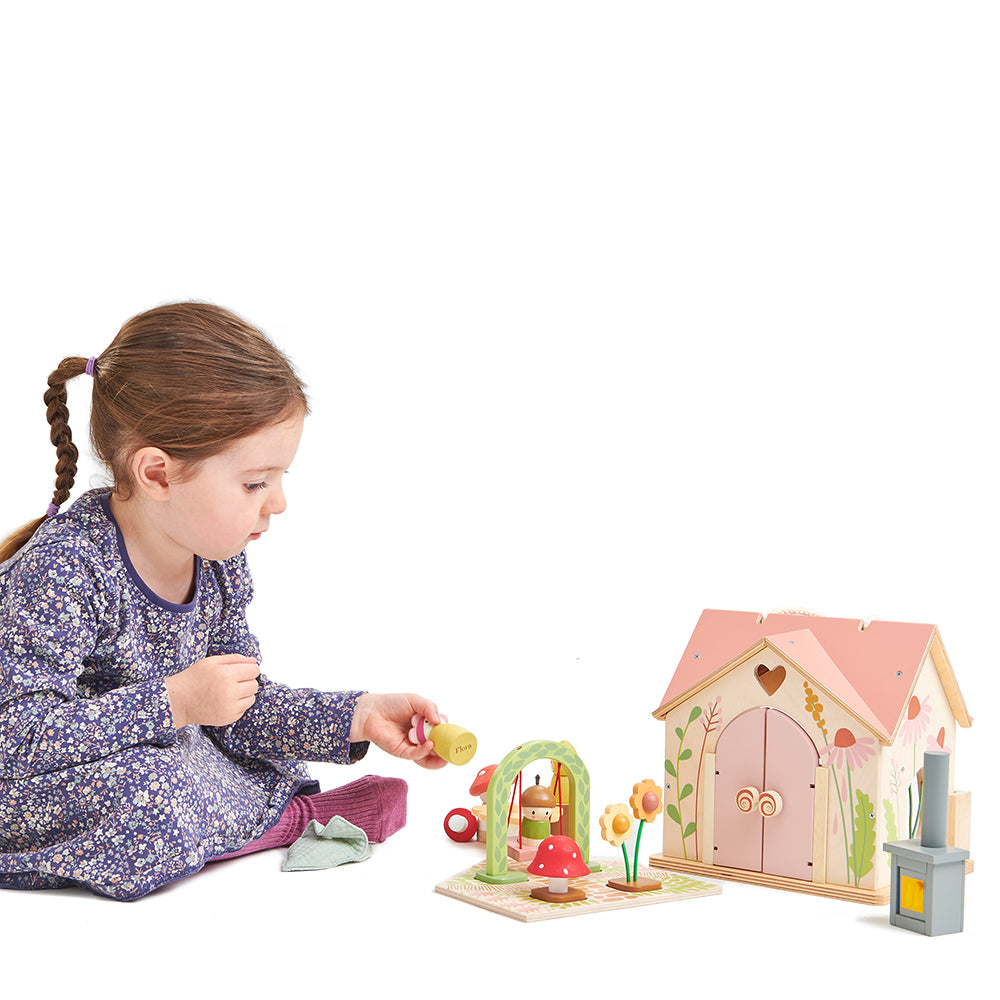 tenderleaf toys plastic free dolls house wood set with doll family and lots of doll house furniture all finished with colour safe paints. Sustainable toys gift ideas for children