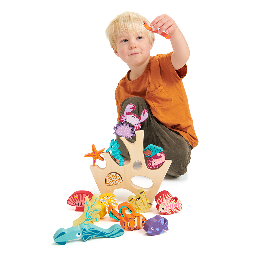 completely plastic free toy wooden stacking under the sea coral rock sea creatures including a shrimp, a squid, a crab, two eels, a sea urchin, a sea anenome, a starfish, a seahorse, three fish, four coral pieces, and a hermit crab.